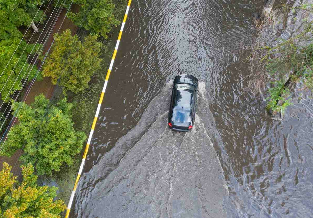 a car driving through a shallow flood